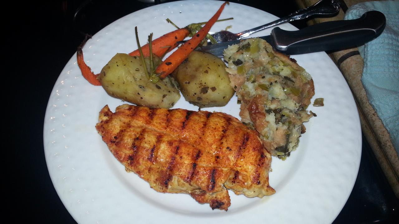 Caribbean Spice Chicken with skinned Potatoes, Stuffing and Carrots.