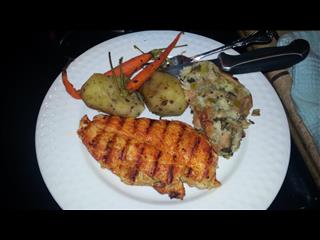 Caribbean Spice Chicken with skinned Potatoes, Stuffing and Carrots.